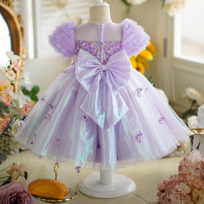 Happy little girl twirling in a beautiful girls short sleeve princess dress.