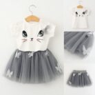 Young girl smiling and twirling in an adorable girls cat print skirt set.
