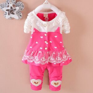 Cute toddler girl smiling in a comfortable toddler girl tracksuit set.