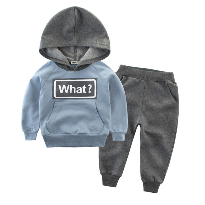 Young child smiling and playing in a comfortable kids cotton two piece set.