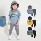Young child smiling and playing in a comfortable kids cotton two piece set.