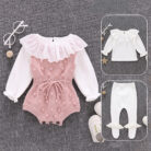 Cute baby girl wearing a cozy, minimalist baby girl long sleeve romper.