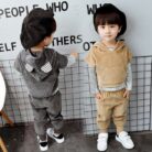 Handsome toddler boy smiling in a stylish boys 3 piece hoodie terno set.