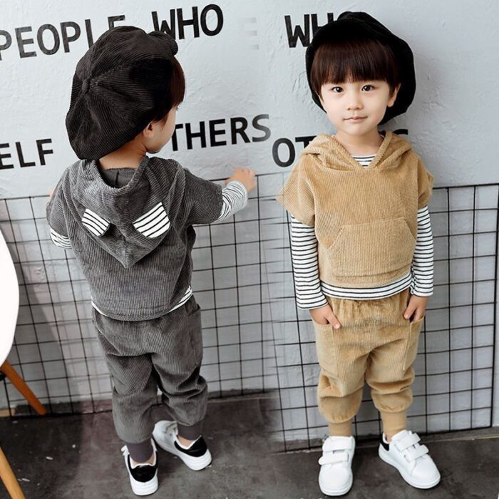 Handsome toddler boy smiling in a stylish boys 3 piece hoodie terno set.