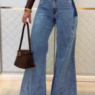 Woman wearing stylish women's high waisted flare jeans in a light blue wash.