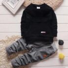 Active toddler playing happily in a comfortable toddler terno set.