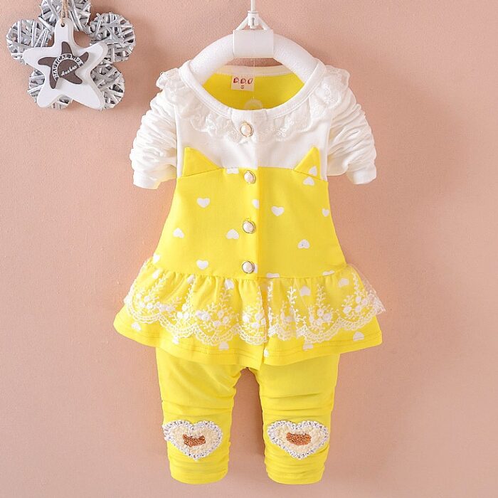 Cute toddler girl smiling in a comfortable toddler girl tracksuit set.