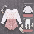 Cute baby girl wearing a cozy, minimalist baby girl long sleeve romper.
