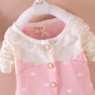 Cute toddler girl smiling in a comfortable toddler girl tracksuit set.