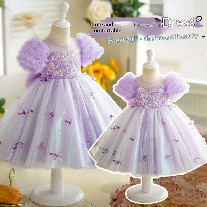 Happy little girl twirling in a beautiful girls short sleeve princess dress.