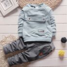 Active toddler playing happily in a comfortable toddler terno set.