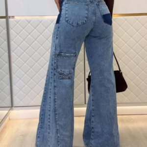 Woman wearing stylish women's high waisted flare jeans in a light blue wash.