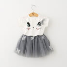 Young girl smiling and twirling in an adorable girls cat print skirt set.