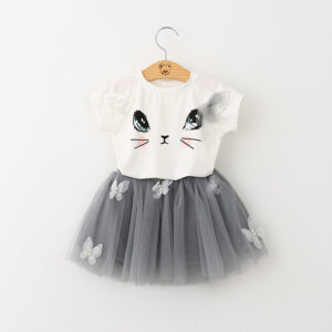 Young girl smiling and twirling in an adorable girls cat print skirt set.