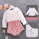 Cute baby girl wearing a cozy, minimalist baby girl long sleeve romper.