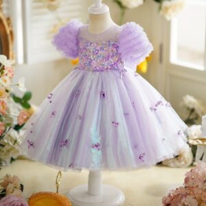 Happy little girl twirling in a beautiful girls short sleeve princess dress.