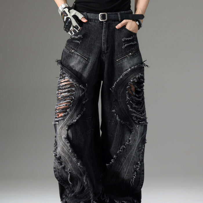 Young man wearing stylish black mens vintage distressed drawstring jeans.