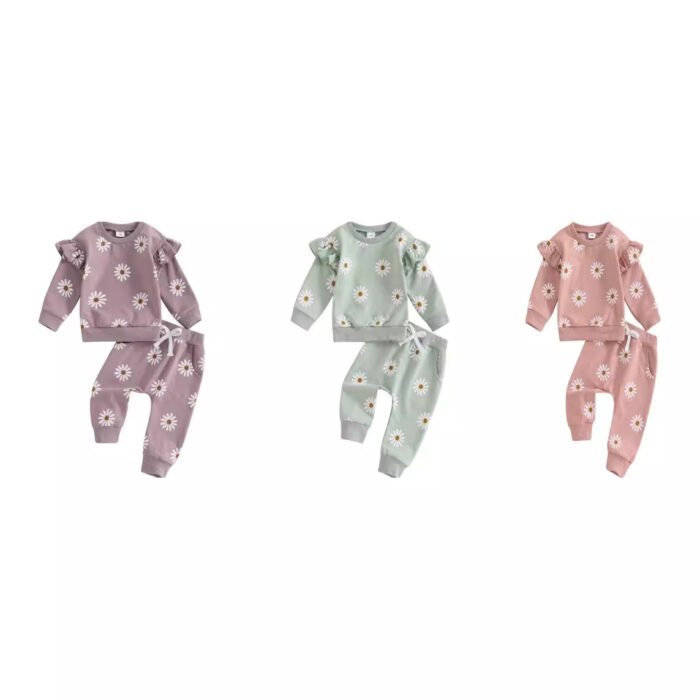 Cute toddler wearing a cozy baby girl floral outfit with a daisy print long-sleeve top and matching pants.
