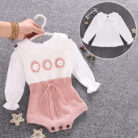Cute baby girl wearing a cozy, minimalist baby girl long sleeve romper.