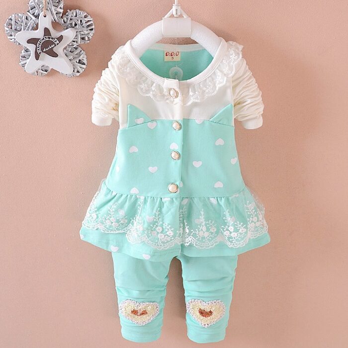 Cute toddler girl smiling in a comfortable toddler girl tracksuit set.