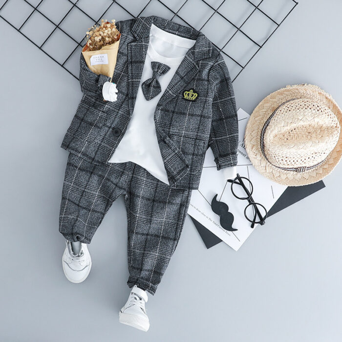 Handsome toddler boy dressed in a stylish boys 3 piece formal terno.