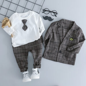 Handsome toddler boy dressed in a stylish boys 3 piece formal terno.