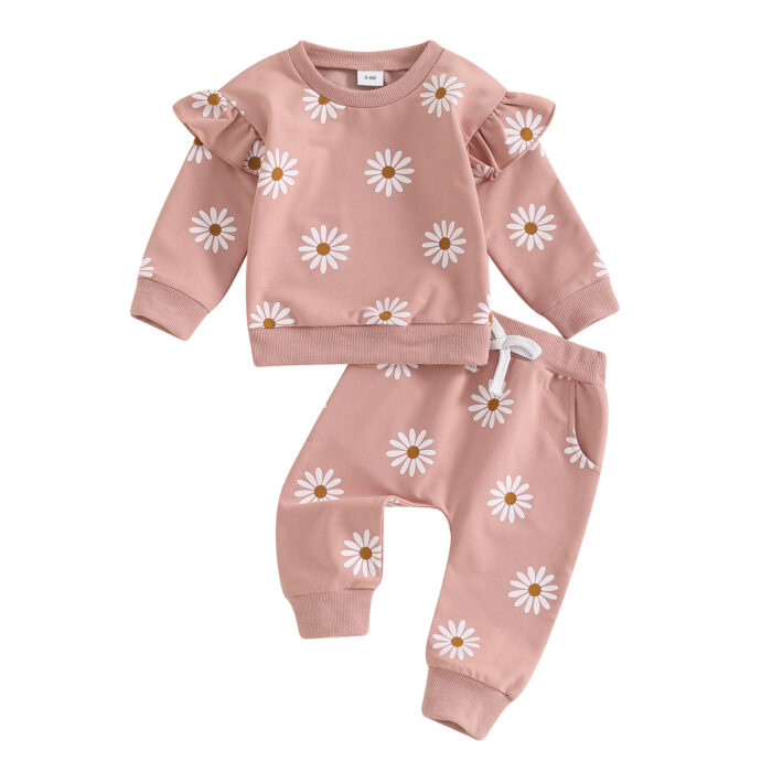 Cute toddler wearing a cozy baby girl floral outfit with a daisy print long-sleeve top and matching pants.