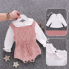 Cute baby girl wearing a cozy, minimalist baby girl long sleeve romper.
