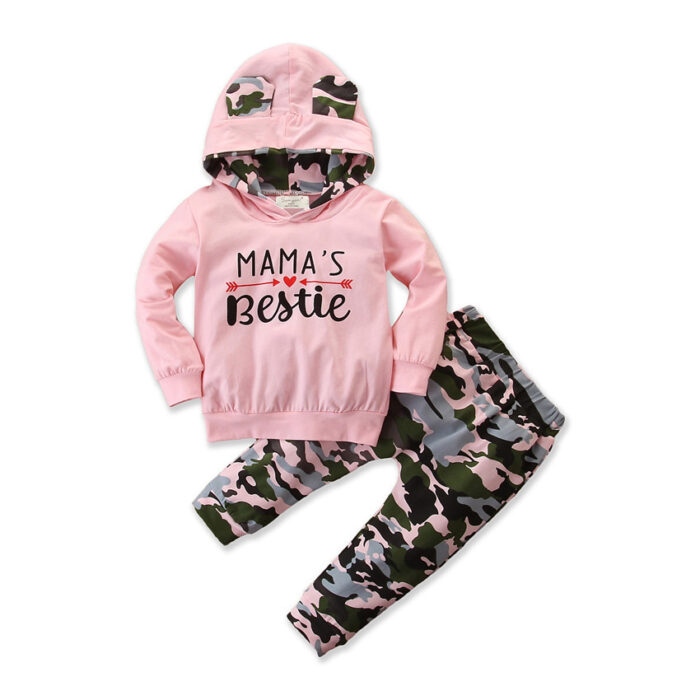 7bbe0d00-ec29-4814-85c4-36d64581228d.jpg Stylish toddler girl smiling outdoors in a trendy pink toddler girl camo outfit.