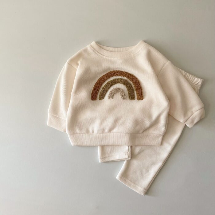 7fd17c38-bfb9-4d21-b4bc-3e1cdf6547e4.jpg Cute baby wearing a neutral creamy-white baby embroidered two piece outfit.