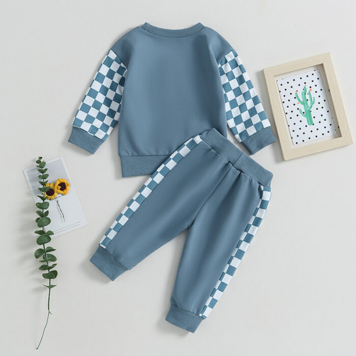 Stylish toddler boy wearing a cool boys checkered sweater terno set.