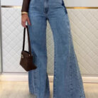 Woman wearing stylish women's high waisted flare jeans in a light blue wash.