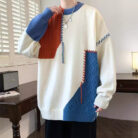 Handsome young man wearing a stylish mens colorblock pullover sweater.