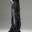 Young man wearing stylish black mens vintage distressed drawstring jeans.