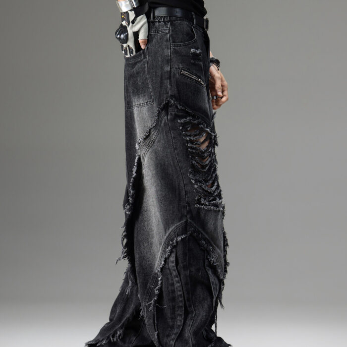 Young man wearing stylish black mens vintage distressed drawstring jeans.