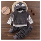 Handsome toddler boy smiling in a stylish boys 3 piece hoodie terno set.