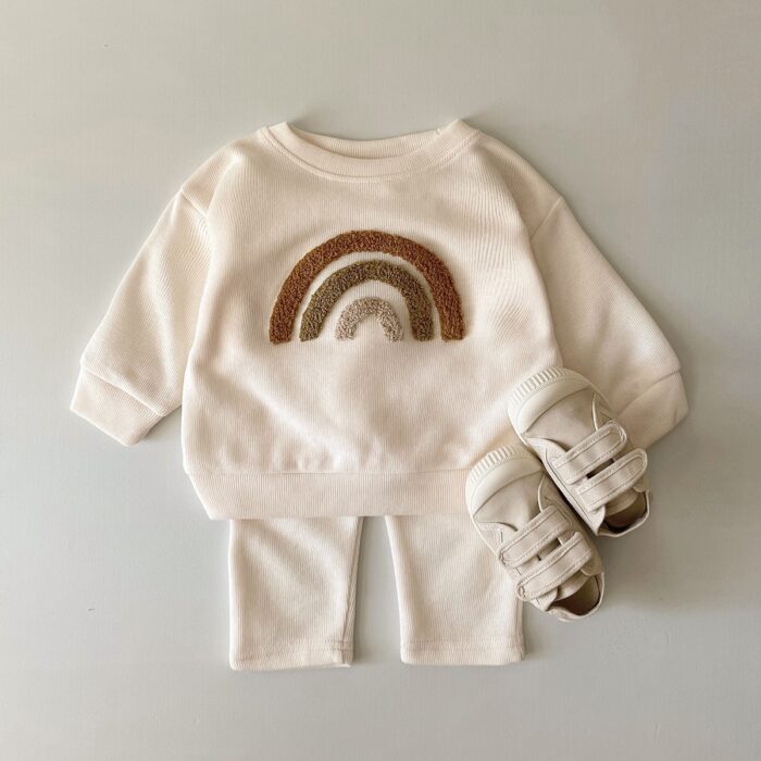 9391acb1-b2af-458d-9e46-899812d41a73.jpg Cute baby wearing a neutral creamy-white baby embroidered two piece outfit.