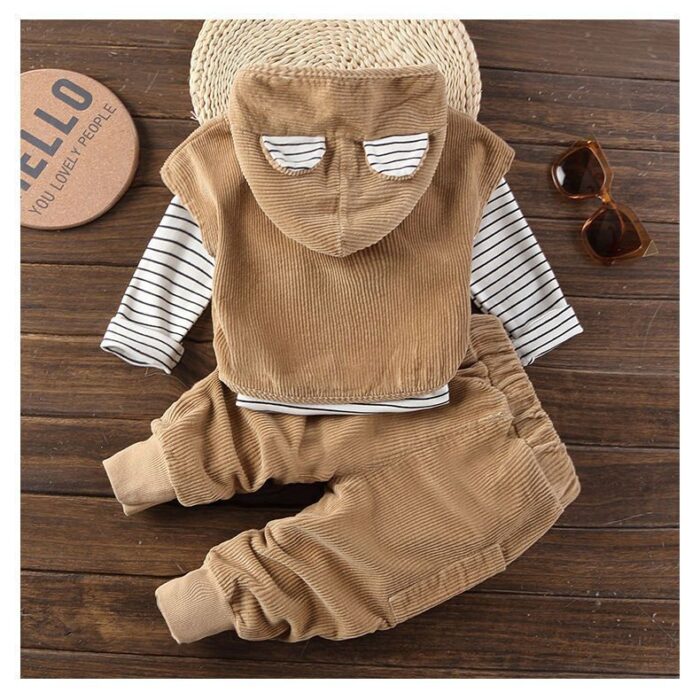 Handsome toddler boy smiling in a stylish boys 3 piece hoodie terno set.