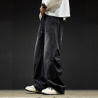 Stylish young man wearing trendy mens wide leg denim cargo pants.