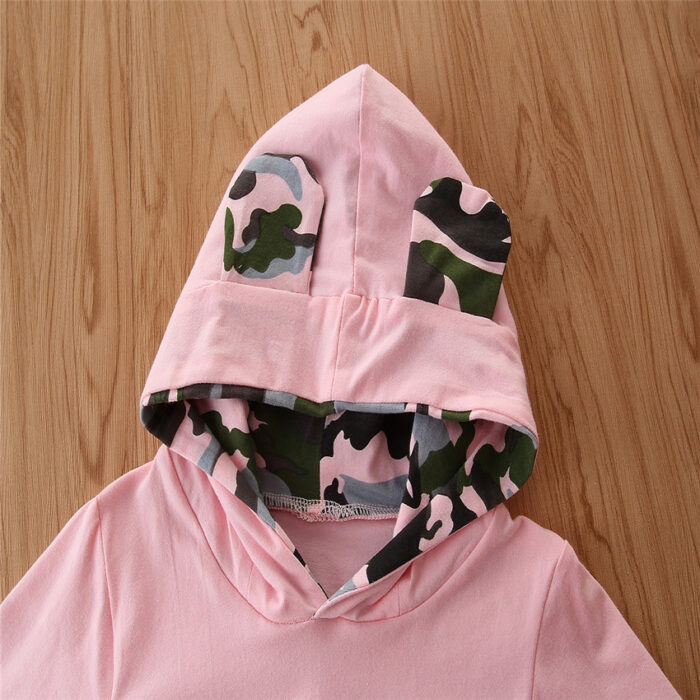 abec9596-c21d-4816-8434-e5e2ce1452a4.jpg Stylish toddler girl smiling outdoors in a trendy pink toddler girl camo outfit.