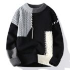 Handsome young man wearing a stylish mens colorblock pullover sweater.