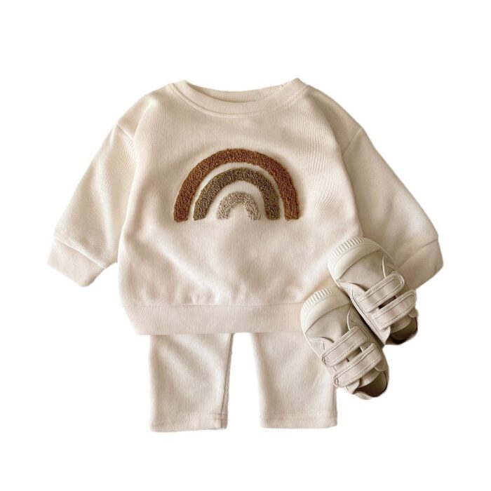 b3e559ad-b610-4170-a336-bcbf053975ef.jpg Cute baby wearing a neutral creamy-white baby embroidered two piece outfit.