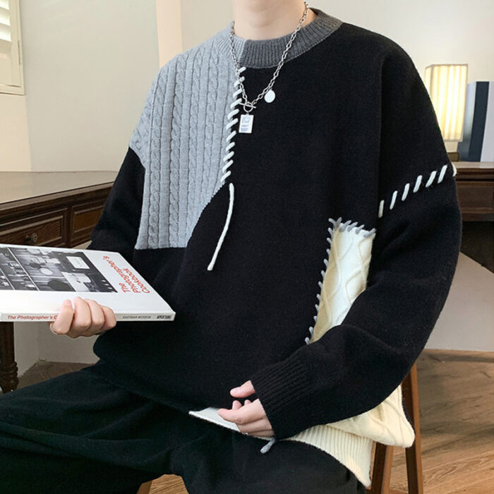 Handsome young man wearing a stylish mens colorblock pullover sweater.