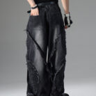 Young man wearing stylish black mens vintage distressed drawstring jeans.