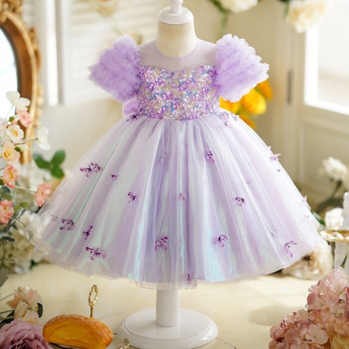 Happy little girl twirling in a beautiful girls short sleeve princess dress.