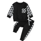 Stylish toddler boy wearing a cool boys checkered sweater terno set.