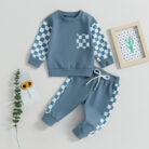 Stylish toddler boy wearing a cool boys checkered sweater terno set.