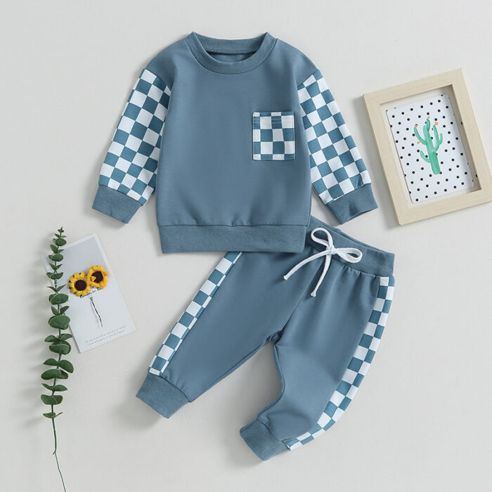 Stylish toddler boy wearing a cool boys checkered sweater terno set.