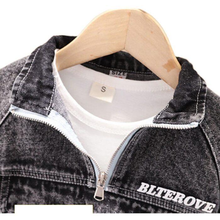 Stylish little boy smiling outdoors in a cool boys denim terno set.