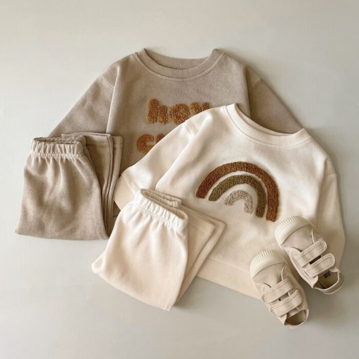 efe4974b-0cf8-45dc-847d-e31e177b98ae.jpg Cute baby wearing a neutral creamy-white baby embroidered two piece outfit.